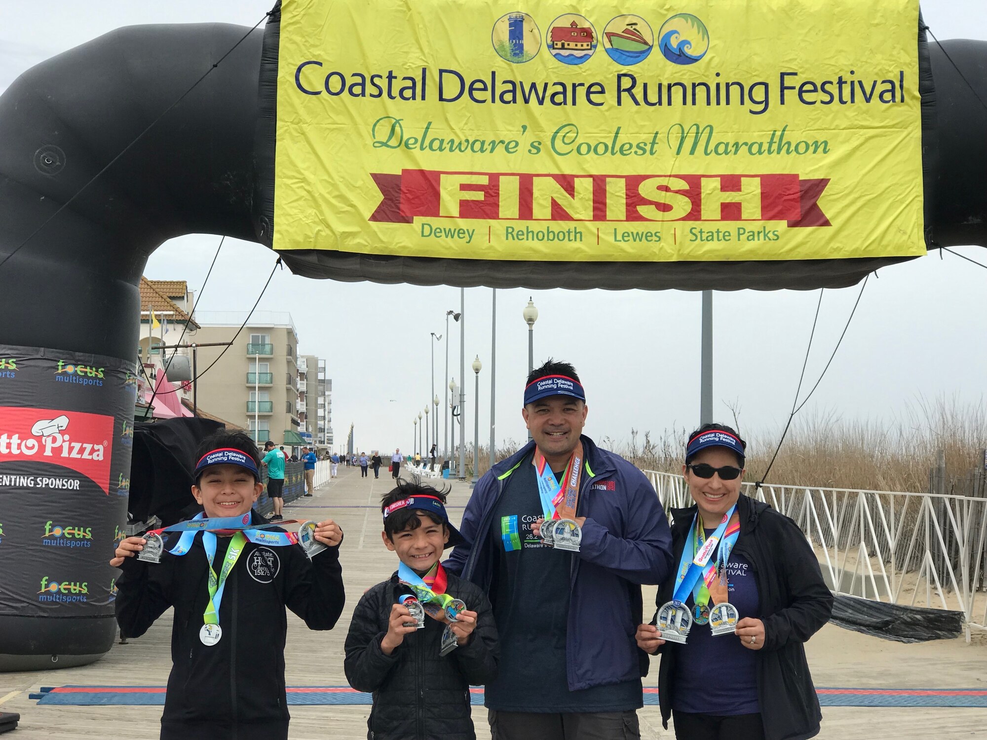 436th Communications Squadron commander Lt. Col. Carlos Jayme (center), wife Jen, and sons Lance (12) and Kyle (9) pose together after running in the Coastal Delaware Running Festival April 13, 2019. During their time stationed at Dover AFB, the family strived to maximize their time together through activities like running races, talent shows and volunteer activities. (Courtesy photo by Lt. Col. Carlos Jayme)