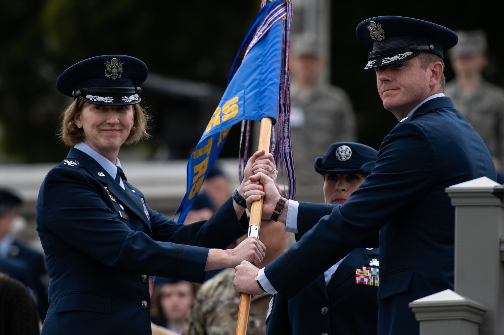 U.S. Air Force Col. Stephanie Kelley, 517th Training Group commander, accepts the guidon from Lt. Col. Brian McCreary, 311th Training Squadron outgoing commander, during the change of command ceremony on Soldier Field, Presidio of Monterey, California, July 8, 2019. McCreary increased the number of 311th TRS Airmen graduating from the Russian language program by 42 percent. (Courtesy Photo)