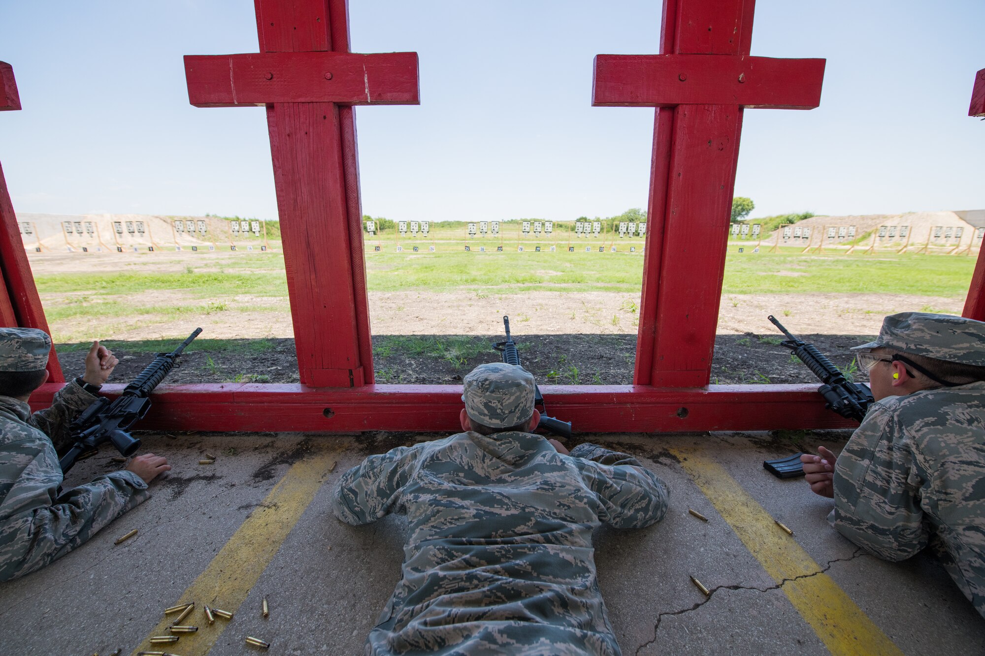 U.S. Air Force basic military training trainees prepare to engage targets during a weapons familiarization course, July 8, 2019, at Joint Base San Antonio-Medina Annex. BMT trainees were the first to experience M-4 Carbine Weapons Familiarization Course at the new facility, which closed in November 2018, due to improper rainwater drainage. The firing range allows instructors to train 244 BMT trainees daily, four days a week, qualifying more than 40,000 BMT trainees in the M-4 carbine annually. (U.S. Air Force photo by Sarayuth Pinthong)