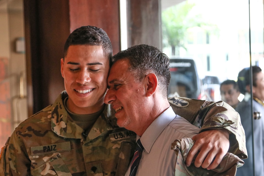 U.S. Army Reserve Spc. Brandon Paiz, a carpentry/masonry specialist with the 358th Engineer Company from Chambersburg, Pennsylvania, embraces his father, Jorge, June 24 at the Intercontinental Hotel in Guatemala City, Guatemala. Paiz, a native of Guatemala, returned to the country for the first time in more than a decade, and also met his father for the first time on the training/partnership mission.