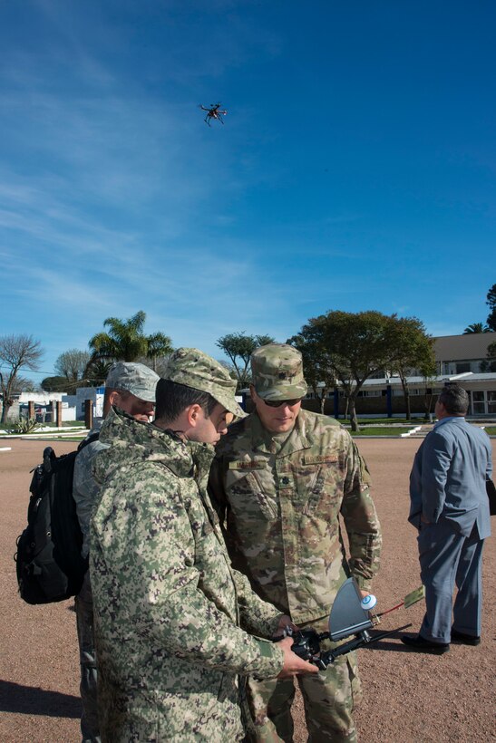 A Uruguayan Army communications specialist shows Lt. Col. Guy Marino, 103rd Air Control Squadron, how their drones operate in Montevideo, Uruguay June 27, 2019. Members of the 103rd Air Control Squadron are in Uruguay to assess the communications and radar capabilities of the Uruguayan military. (U.S. Air National Guard photo by Capt. Jen Pierce)
