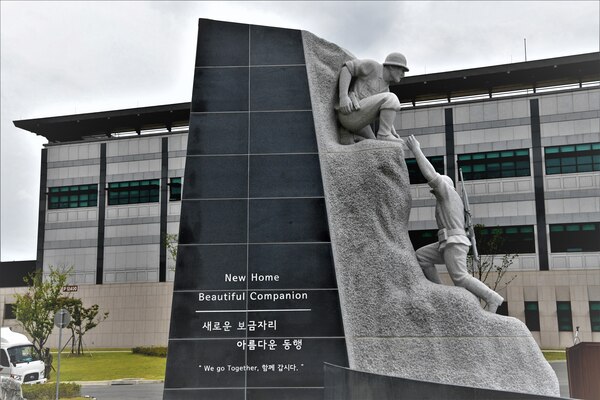 The ROK-U.S. Alliance sculpture is unveiled during a ceremony July 10 at the United States Forces Korea Headquarters building, Camp Humphreys, Republic of Korea. The sculpture consists of five segments representing the U.S.-ROK alliance with the theme, “Tomorrow as One, Beautiful Companion.” Each segment symbolizes the commitment of service members, the history of the alliance, and the military branches of each nation. The main tower symbolizes the Korean War and Operation Chromite.