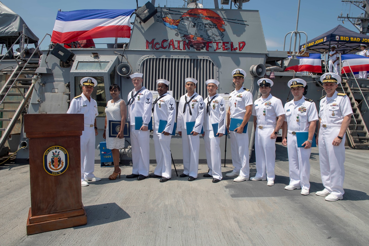 YOKOSUKA, Japan (July 2, 2019) Adm. John Aquilino, commander, U.S. Pacific Fleet (left) and Vice Adm. Phil Sawyer, commander, U.S. 7th Fleet (right) pose for a photo with awardees after an awards ceremony recognizing 50 Sailors who distinguished themselves for their bravery and contributions to damage control efforts during the 2017 collision aboard the guided-missile destroyer USS John S. McCain (DDG 56), currently berthed at Commander, Fleet Activities Yokosuka, Japan. The awards represent all those who distinguished themselves by heroism, outstanding achievement or meritorious service following the ship’s collision with the merchant vessel Alnic MC Aug. 21, 2017.