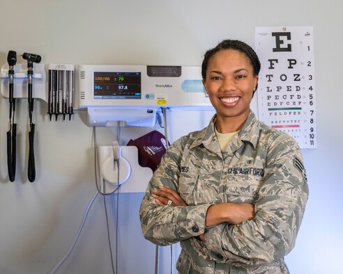 Senior Airman Kaylan James, Flight and Operation Medical Technician assigned to the 913th Aerospace Medicine Squadron, poses in front of medical equipment in an exam room, June 13, 2019 at Little Rock Air Force Base, Arkansas. Senior Airman James’ future aspirations are to commission and become an Aeromedical Evacuation Nurse. (U.S. Air Force Reserve photo by Maj. Ashley Walker)