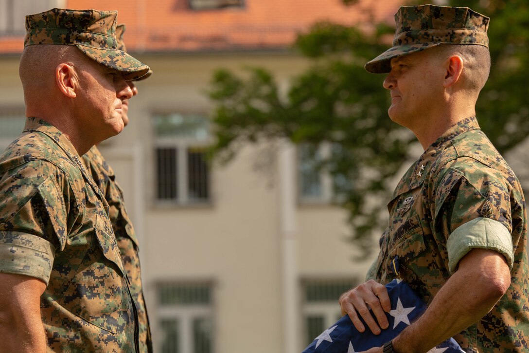 U.S. Marine Corps Maj. Gen. Russel A.C. Sanborn, the outgoing commander of U.S. Marine Forces Europe and Africa, receives a retirement flag flown over the Battle of Belleau Wood memorial from Lt. Gen. Robert F. Hedelund, the commander of U.S. Marine Corps Forces Command, during the change of command and retirement ceremony on the Devil Dog Field on Panzer Kaserne in Boeblingen, Germany, July 9, 2019. Sanborn, who commanded MARFOREUR/AF since July 2017, presided over several initiatives that grew the headquarters as a dynamic warfighting institution, to include increasing NATO capacity for allied amphibious operations; enhanced naval and amphibious integration into plans, operations and exercises; the expansion of the Marine Corps cold-weather and mountain-warfare rotational training presence in Norway's high north; and responsibility for U.S. forces participating in Exercise Trident Juncture 2018, the largest NATO military exercise since the end of the Cold War. (U.S. Marine Corps photo by Lance Cpl. Joseph Atiyeh)