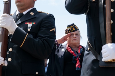 Lt. Col. (ret.) Jennifer Pritzker, founder of the Pritzker Military Museum and Library in Chicago, salutes the color guard