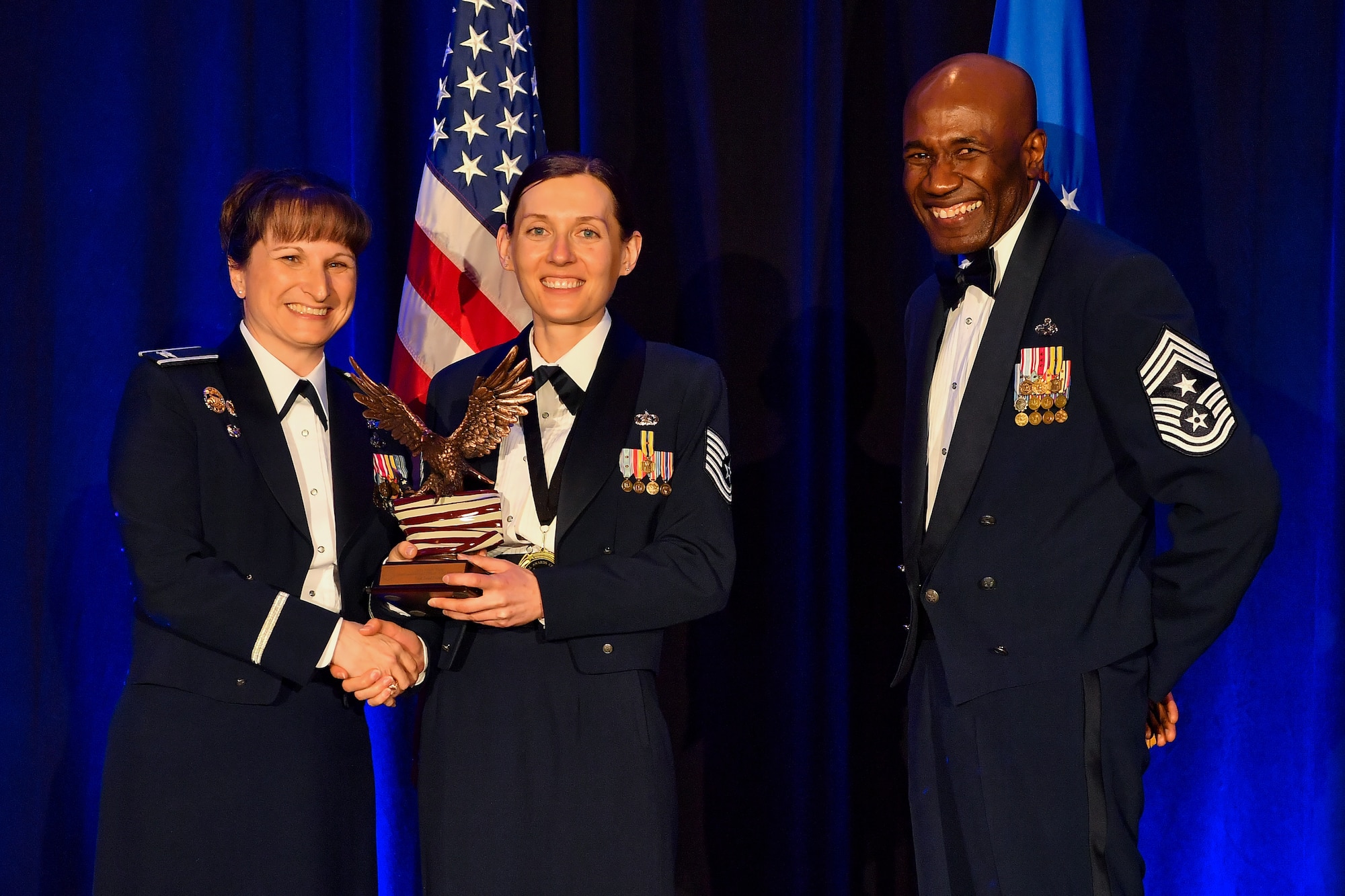 Tech. Sgt. Inna Lvova, 50th Comptroller Squadron noncommissioned officer in charge of financial analysis, holds an award for winning 50th Space Wing NCO of the Year award March 8, 2019, Colorado Springs, Colorado. After winning NCO of the year for the 50th Space Wing, Lvova earned the 12 Outstanding Airmen of the Year Award, NCO category, for the Air Force. (U.S. Air Force photo by Kathryn Calvert)