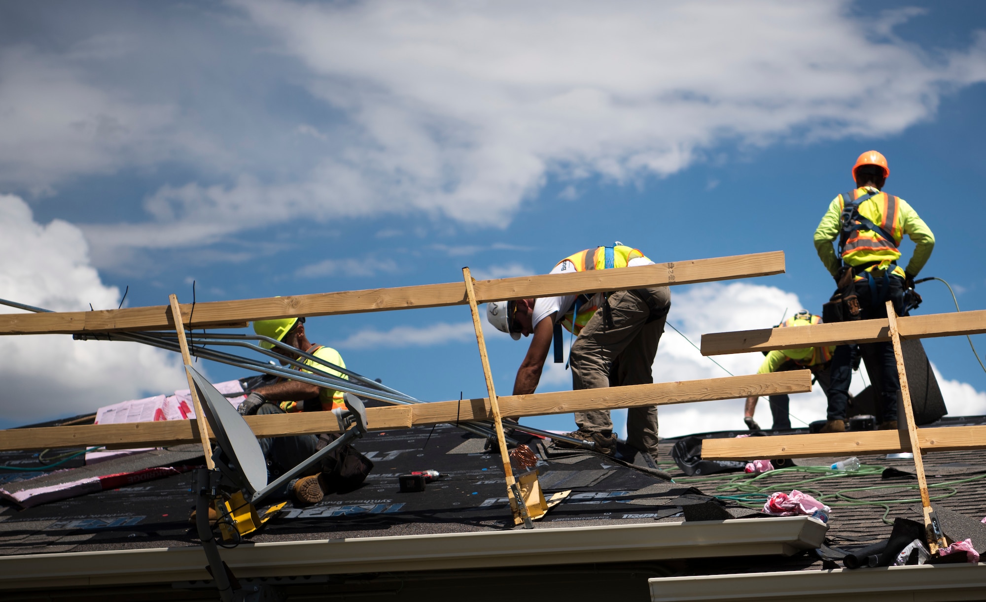 Construction workers replace the shingles on roofs at the Tierra Vista Communities at Schriever Air Force Base, Colorado, July 8, 2019. The project is meant to repair damage from a hailstorm in 2018 and provide a longer lifespan for houses. (U.S. Air Force photo by Airman 1st Class Jonathan Whitely)