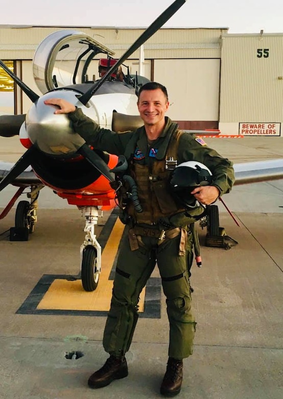 Man stands in front of plane.