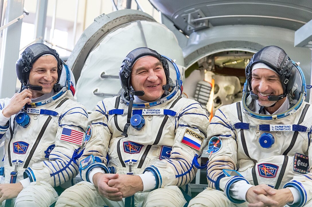 Three astronauts pose for photo.