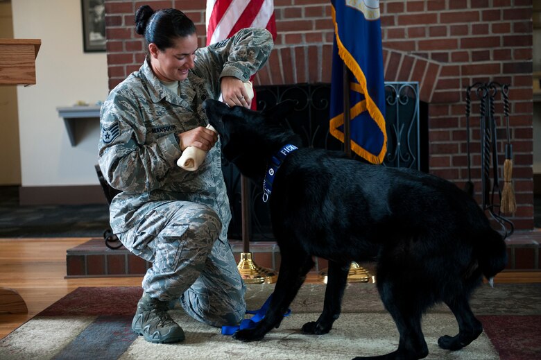 Staff Sgt. Renee Mansour, 23d Security Forces Squadron military working dog (MWD) handler, plays with retired MWD Ficko, Sept. 15, 2015, at Moody Air Force Base, Ga.  Mansour was recently selected to become a military training instructor, departing for Joint Base San Antonio-Lackland, Texas in August. Mansour believes the skills she’s gained from leading the kennel program will help her shape and lead future Airmen. (U.S. Air Force photo by Airman 1st Class Kathleen D. Bryant)