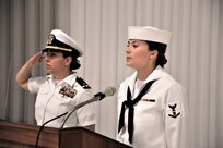 IMAGE: (Left to right) Chief Warrant Officer Josephine Leon, master of ceremony, renders a salute prior to Musician 3rd Class Amanda Huddleston, Fleet Forces Band, singing the national anthem. More than 200 Sailors and guests attended a traditional change of command ceremony at Naval Air Station (NAS) Oceana’s Center for Naval Aviation Technical Training Unit’s ceremonial hangar aboard NAS Oceana June 27 where Cmdr. Andrew Hoffman was relieved of command by Cmdr. Joseph Oravec. Oravec became the 28th commanding officer, Naval Surface Warfare Center Dahlgren Division, Dam Neck Activity.