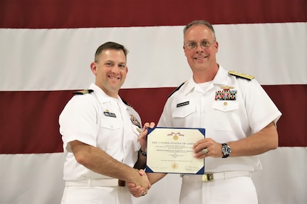 IMAGE: (Left to right) Cmdr. Andrew Hoffman receives the Meritorious Service Medal (Gold Star in lieu of the Second Award) from Rear Adm. Eric Ver Hage, Commander NAVSEA Warfare Centers, for his achievements as Naval Surface Warfare Center Dahlgren Division, Dam Neck Activity’s commanding officer. More than 200 Sailors and guests attended a traditional Change of Command ceremony at Naval Air Station (NAS) Oceana’s Center for Naval Aviation Technical Training Unit’s ceremonial hangar aboard NAS Oceana June 27 where Hoffman was relieved of command by Cmdr. Joseph Oravec. Oravec became the command’s 28th commanding officer.