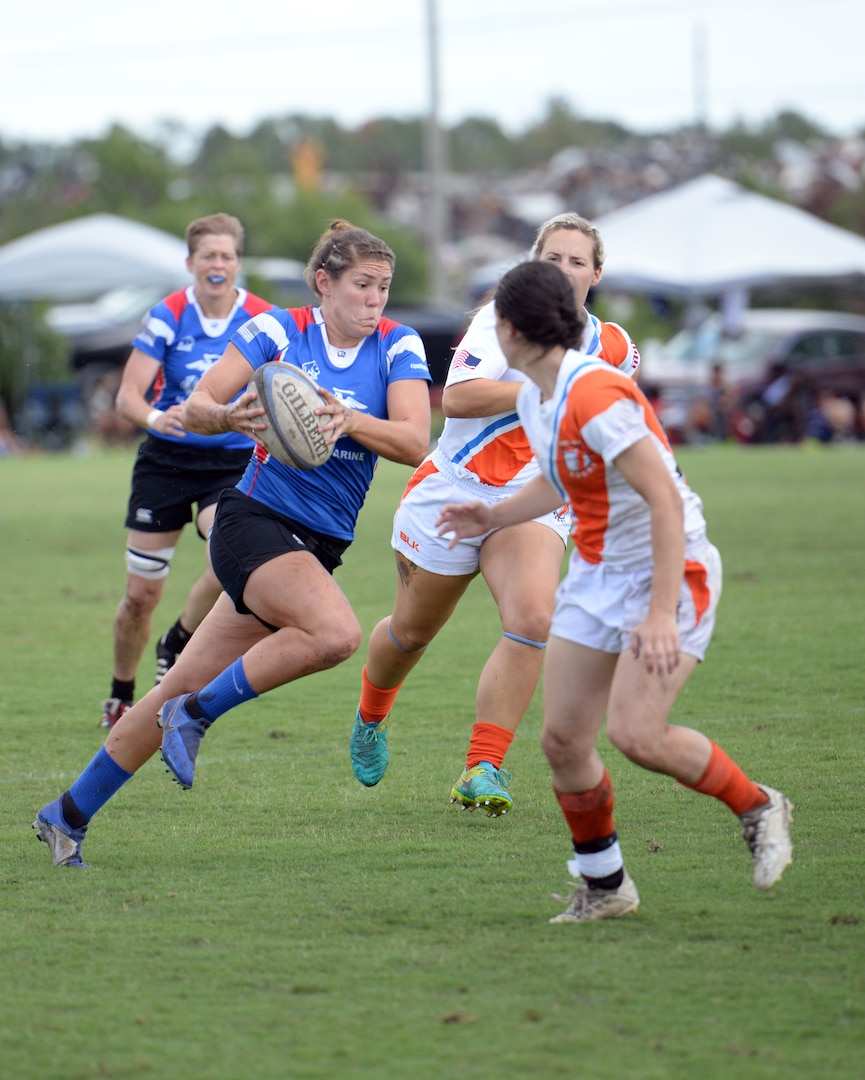 WILMINGTON, N.C. (June 6, 2019) -- Capt. Kate Herren carries the ball down the pitch during the Marine Corps-Coast Guard rugby match on day two of the inaugural Armed Forces Women's Rugby Championship held in Wilmington, N.C. July 5-7, 2019. This historic event features the best female rugby players from the Army, Marine Corps, Navy, Air Force, and Coast Guard, who will compete for the title of the first ever Women's Rugby Champs (U.S. Dept. of Defense photo by Chief Mass Communication Specialist Patrick Gordon/RELEASED)