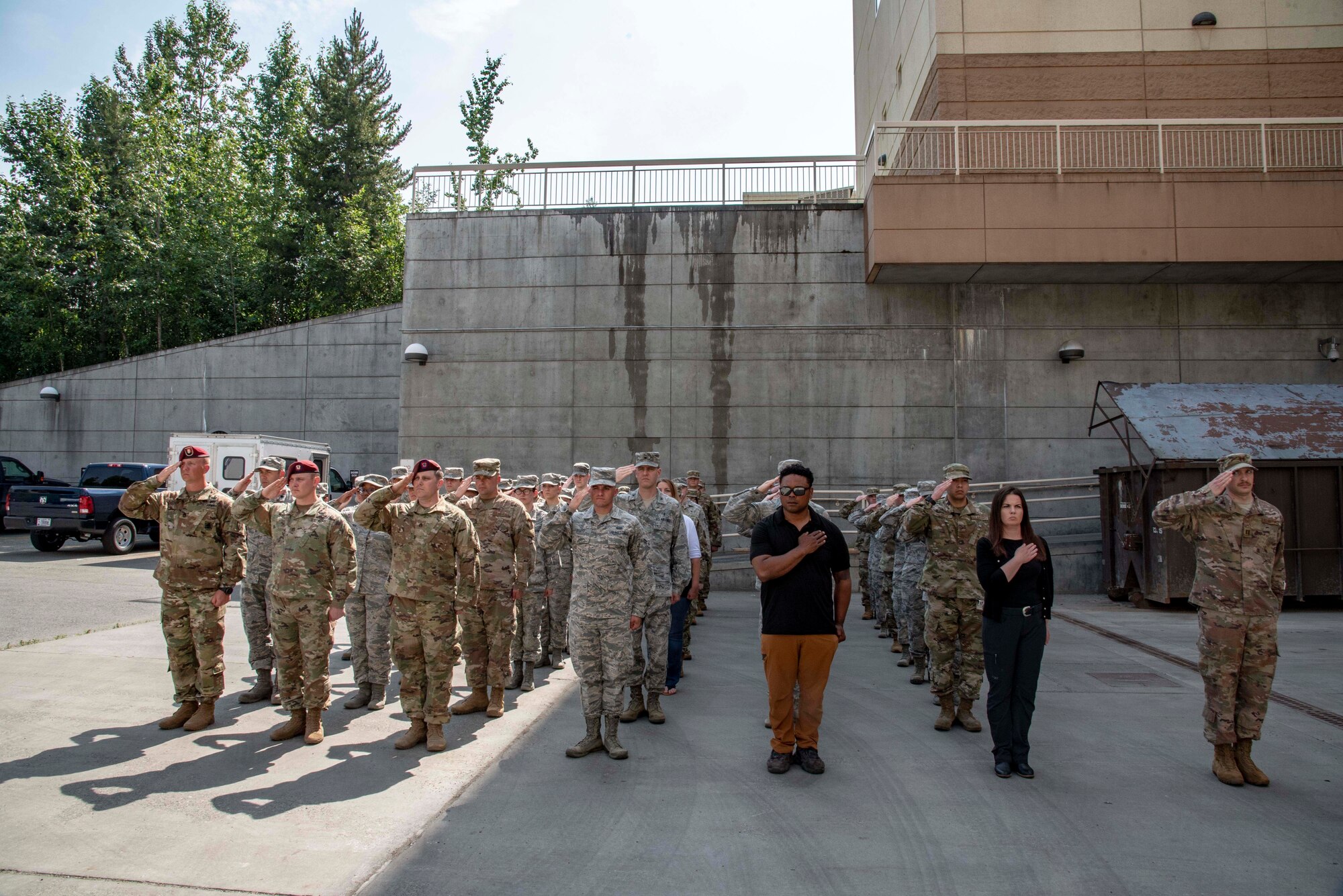 Service members assigned to Joint Base Elmendorf-Richardson, Alaska, and Armed Forces Medical Examiner System medicolegal investigators, stand in formation during a dignified departure at the 673rd Medical Group for remains found on Colony Glacier. The remains were then escorted to Dover Air Force Base, Delaware, where AFMES could begin the process of identifying the remains. (U.S Air Force photo by Staff Sgt. Nicole Leidholm)