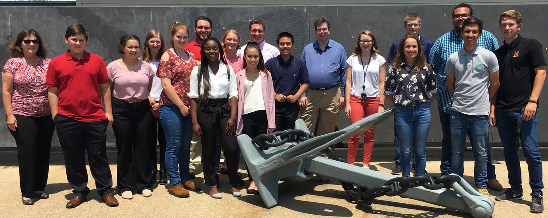 IMAGE: DAHLGREN, Va. (July 2, 2019) - Students from Virginia and Maryland high schools participating in the Science and Engineering Apprenticeship Program at Naval Surface Warfare Center (NSWC) Dahlgren Division and NSWC Indian Head Explosive Ordnance Disposal Technology Division pause - with an engineer from both commands - in front of the Potomac River Test Range metal map during their tour.