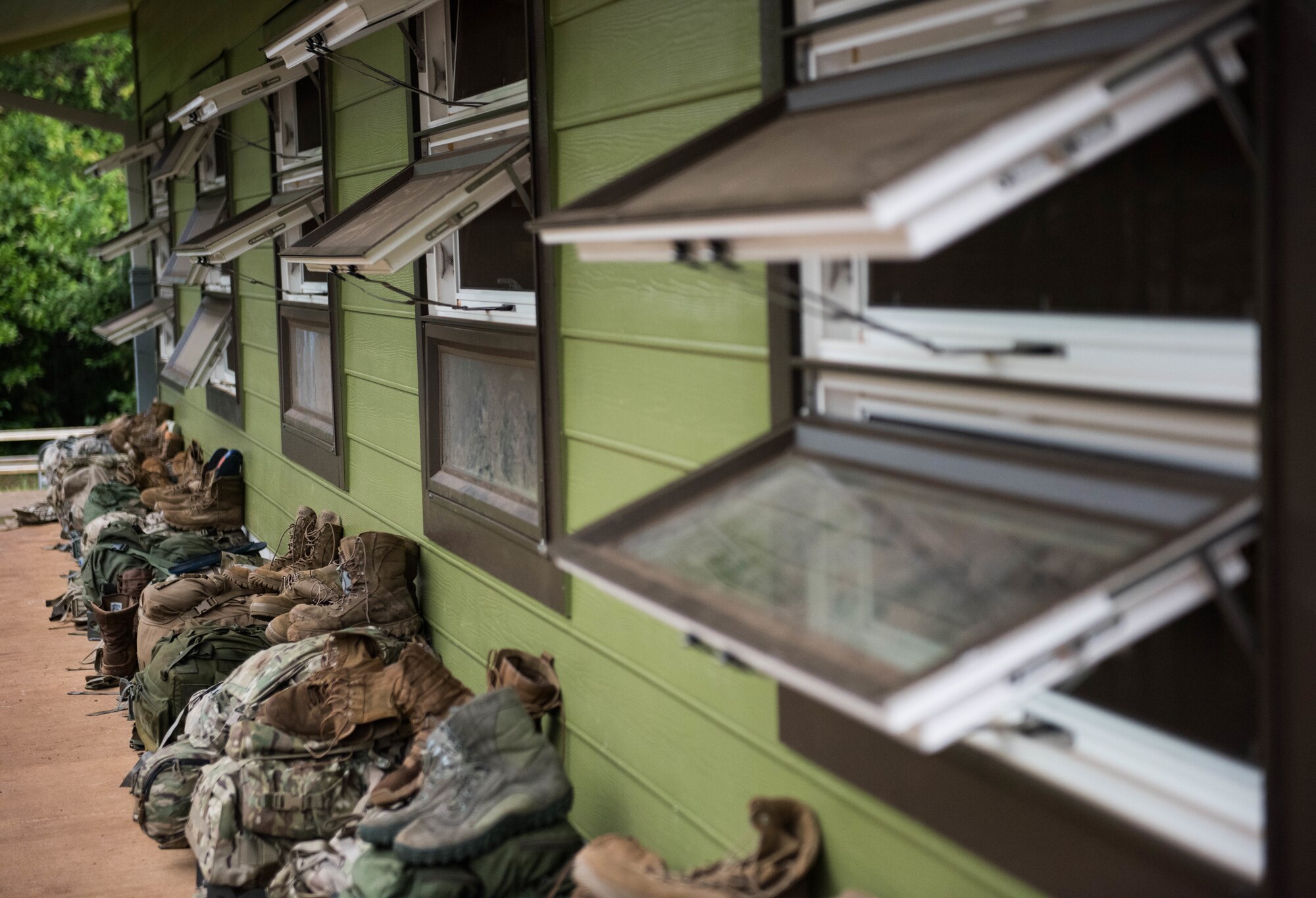 Airmen’s rucks and uniform items sit outside their barracks during a three-week Ranger Assessment Course near Schofield Barracks, Oahu, Hawaii, May 13, 2019. The purpose of the 19-day course is to prepare, assess and evaluate Air Force candidates for Army Ranger School. The Airmen who pass the RAC gain more than a ticket into Ranger School and knowledge on Army tactics – they learn to lead. (U.S. Air Force photo by Staff Sgt. Hailey Haux)