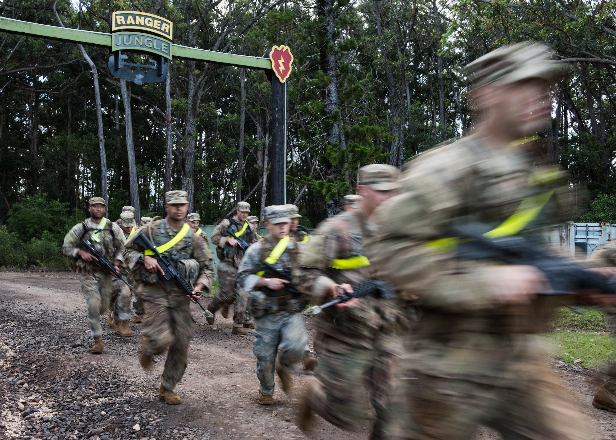 Airmen begin a two-mile run for a Ranger Assessment Course through the hills of a training camp near Schofield Barracks, Oahu, Hawaii, May 20, 2019. The purpose of the 19-day course is to prepare, assess and evaluate Air Force candidates for Army Ranger School. Of the 23 Airmen who began the Ranger Assessment Course, three dropped for personal motivational reasons and one dropped for medical reasons, leaving 19 standing at the end. Out of the 19, 11 Airmen met all the standards needed for a recommendation to go forward to Ranger School. (U.S. Air Force photo by Staff Sgt. Hailey Haux)