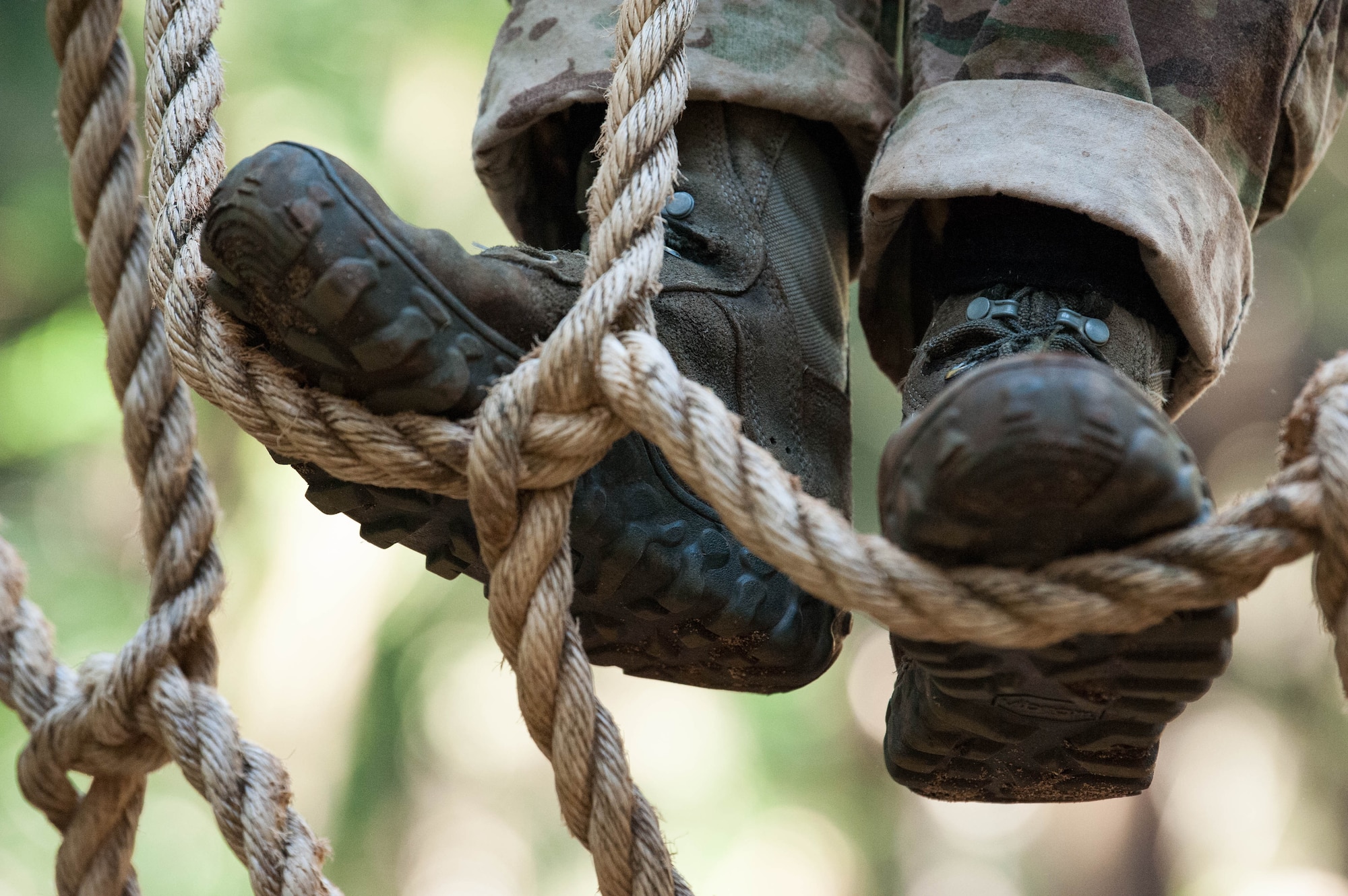 A Ranger Assessment Course student climbs down a rope ladder during the obstacle course phase of RAC near Schofield Barracks, Oahu, Hawaii, May 20, 2019. The purpose of the 19-day course is to prepare, assess and evaluate Air Force candidates for Army Ranger School. The Airmen who pass the RAC gain more than a ticket into Ranger School and knowledge on Army tactics – they learn to lead. (U.S. Air Force photo by Staff Sgt. Hailey Haux)