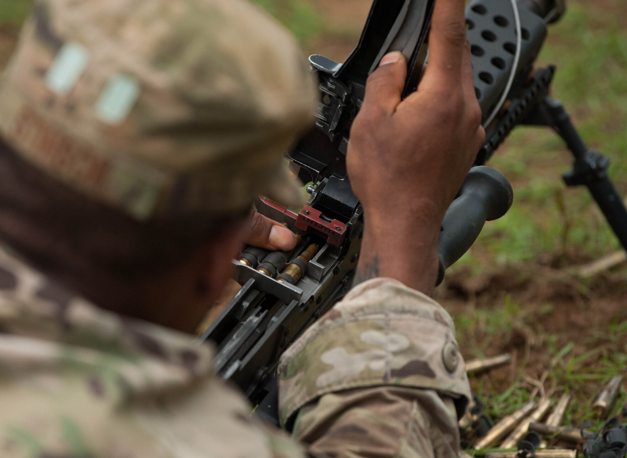Tech. Sgt. Justin Stinson, Ranger Assessment Course student, loads his weapon and practices un-jamming it during the RAC near Schofield Barracks, Oahu, Hawaii, May 20, 2019. The Airmen who pass the Ranger Assessment Course gain more than a ticket into Ranger School and knowledge on Army tactics – they learn to lead. Throughout the course, Airmen were tested on their ability to perform land navigation, ambush, react to contact and squad attacks. Along with those assessments, the students went on runs and marches of different distances – all leading up to a 12-mile ruck march two days before graduation. (U.S. Air Force photo by Staff Sgt. Hailey Haux)
