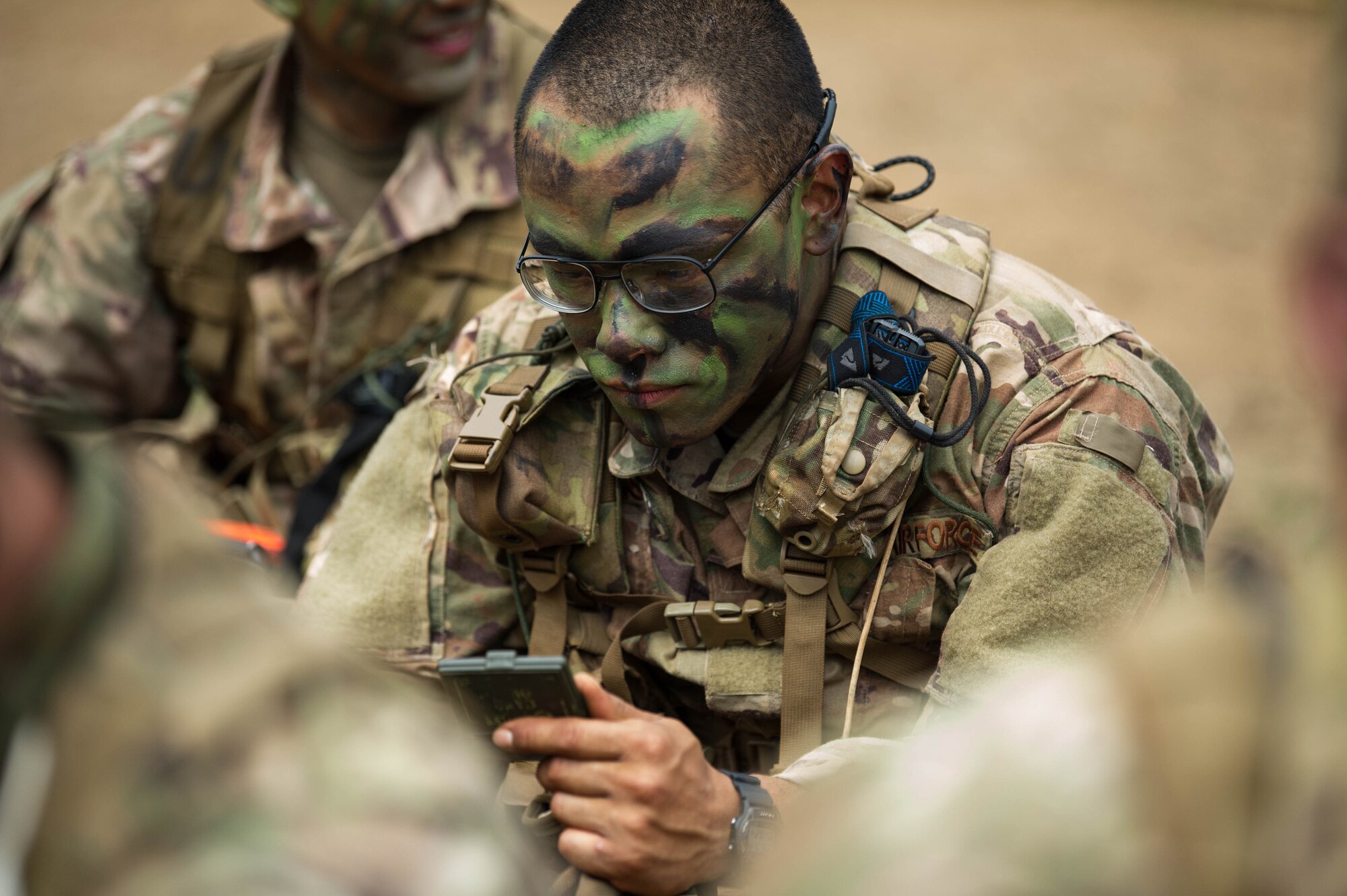 Staff Sgt. Jose Obregon, Ranger Assessment Course student, applies face camouflage before going into the field near Schofield Barracks, Oahu, Hawaii, May 23, 2019.  The Airmen who pass the Ranger Assessment Course gain more than a ticket into Ranger School and knowledge on Army tactics – they learn to lead. (U.S. Air Force photo by Staff Sgt. Hailey Haux)