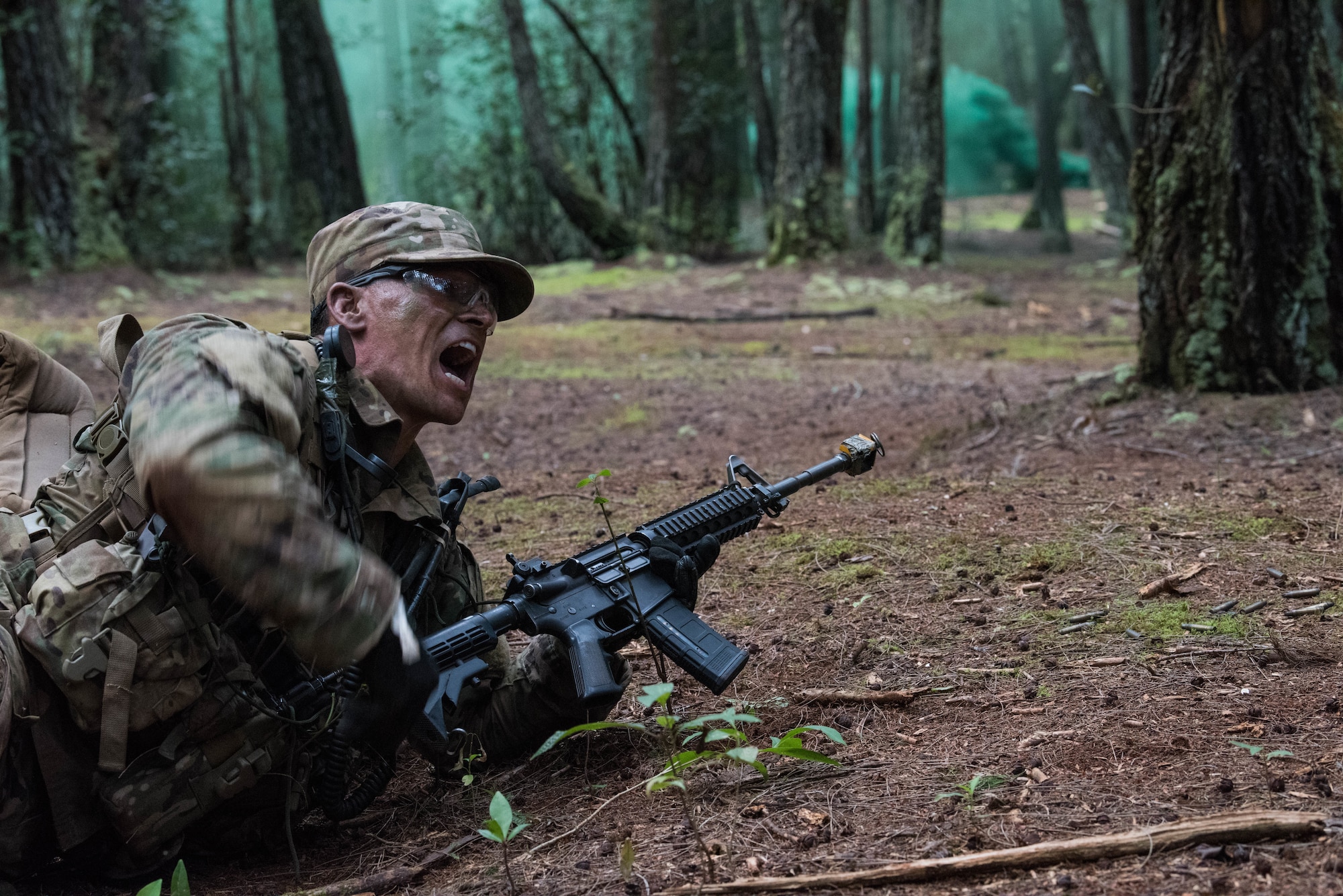 1st Lt. Reece Hudgeons, Ranger Assessment Course student, instructs his squad to get into position during a react to contact with opposing forces near Schofield Barracks, Oahu, Hawaii, May 23, 2019. Twenty-three Airmen from across the Air Force recently converged on a training camp for a three-week Ranger Assessment Course May 12-31, 2019. Throughout the course, Airmen were tested on their ability to perform land navigation, ambush, react to contact and squad attacks. Along with those assessments, the students went on runs and marches of different distances – all leading up to a 12-mile ruck march two days before graduation. (U.S. Air Force photo by Staff Sgt. Hailey Haux)