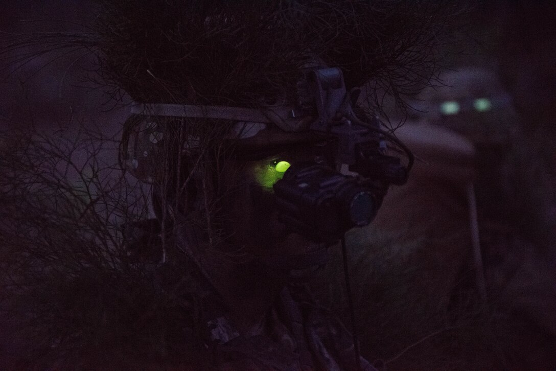 Senior Airman Kimball Butler, Ranger Assessment Course student, dons his night vision gear and prepares for a simulated ambush during training near Schofield Barracks, Oahu, Hawaii, May 23, 2019. Twenty-three Airmen from across the Air Force recently converged on a training camp for a three-week Ranger Assessment Course May 12-31, 2019. The purpose of the 19-day course is to prepare, assess and evaluate Air Force candidates for Army Ranger School. (U.S. Air Force photo by Staff Sgt. Hailey Haux)