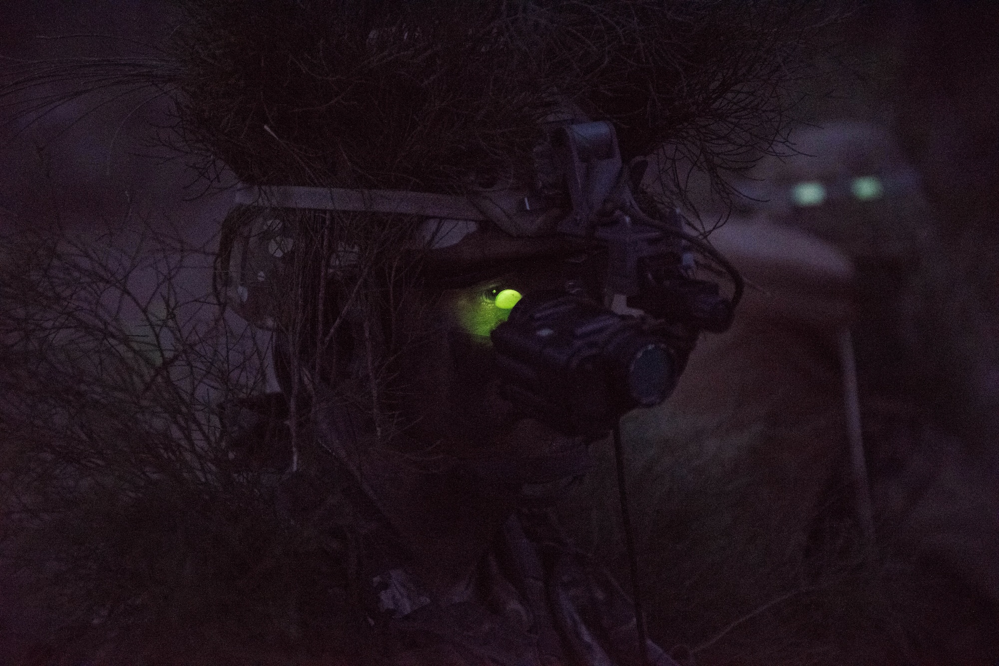 Senior Airman Kimball Butler, Ranger Assessment Course student, dons his night vision gear and prepares for a simulated ambush during training near Schofield Barracks, Oahu, Hawaii, May 23, 2019. Twenty-three Airmen from across the Air Force recently converged on a training camp for a three-week Ranger Assessment Course May 12-31, 2019. The purpose of the 19-day course is to prepare, assess and evaluate Air Force candidates for Army Ranger School. (U.S. Air Force photo by Staff Sgt. Hailey Haux)