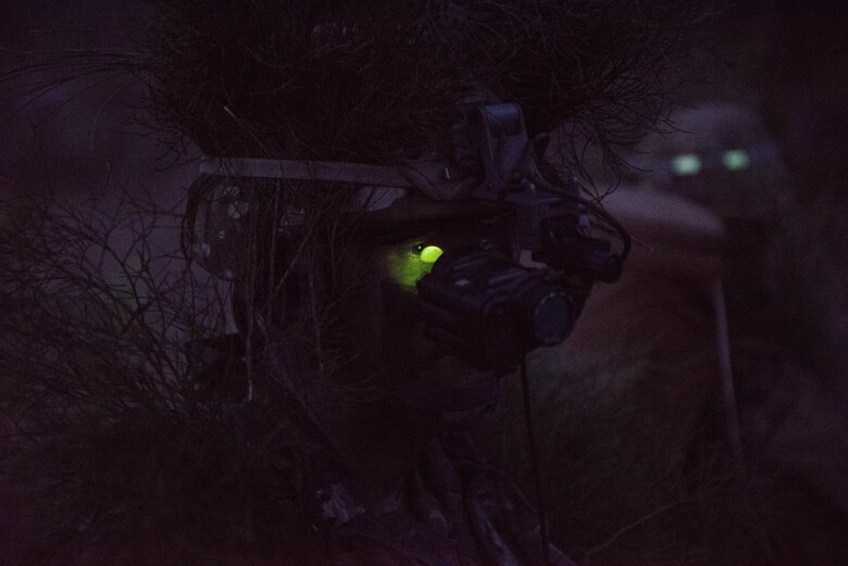 Senior Airman Kimball Butler, Ranger Assessment Course student, dons his night vision gear and prepares for a simulated ambush during training near Schofield Barracks, Oahu, Hawaii, May 23, 2019. Twenty-three Airmen from across the Air Force recently converged on a training camp for a three-week Ranger Assessment Course May 12-31, 2019. The purpose of the 19-day course is to prepare, assess and evaluate Air Force candidates for Army Ranger School. (U.S. Air Force photo by Staff Sgt. Hailey Haux)