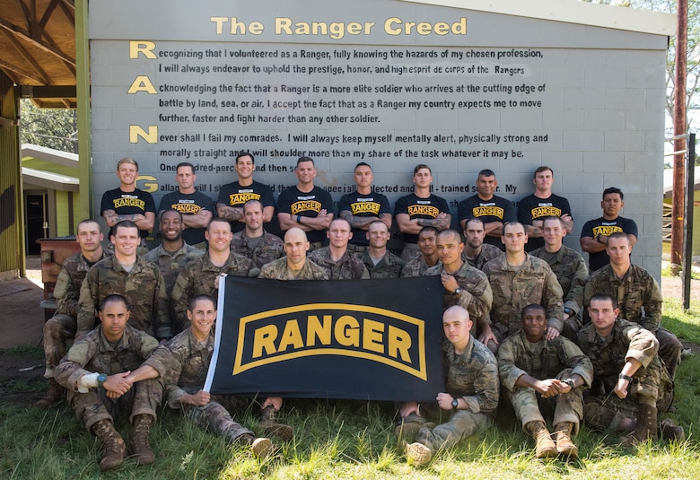 Ranger Assessment Course students and cadre pose for a group photo at the end of the 19-day course near Schofield Barracks, Oahu, Hawaii, May 29, 2019. The purpose of the three-week course is to prepare, assess and evaluate Air Force candidates for Army Ranger School. Of the 23 Airmen who began the Ranger Assessment Course, three dropped for personal motivational reasons and one dropped for medical reasons, leaving 19 standing at the end. Out of the 19, 11 Airmen met all the standards needed for a recommendation to go forward to Ranger School. (U.S. Air Force photo by Staff Sgt. Hailey Haux)