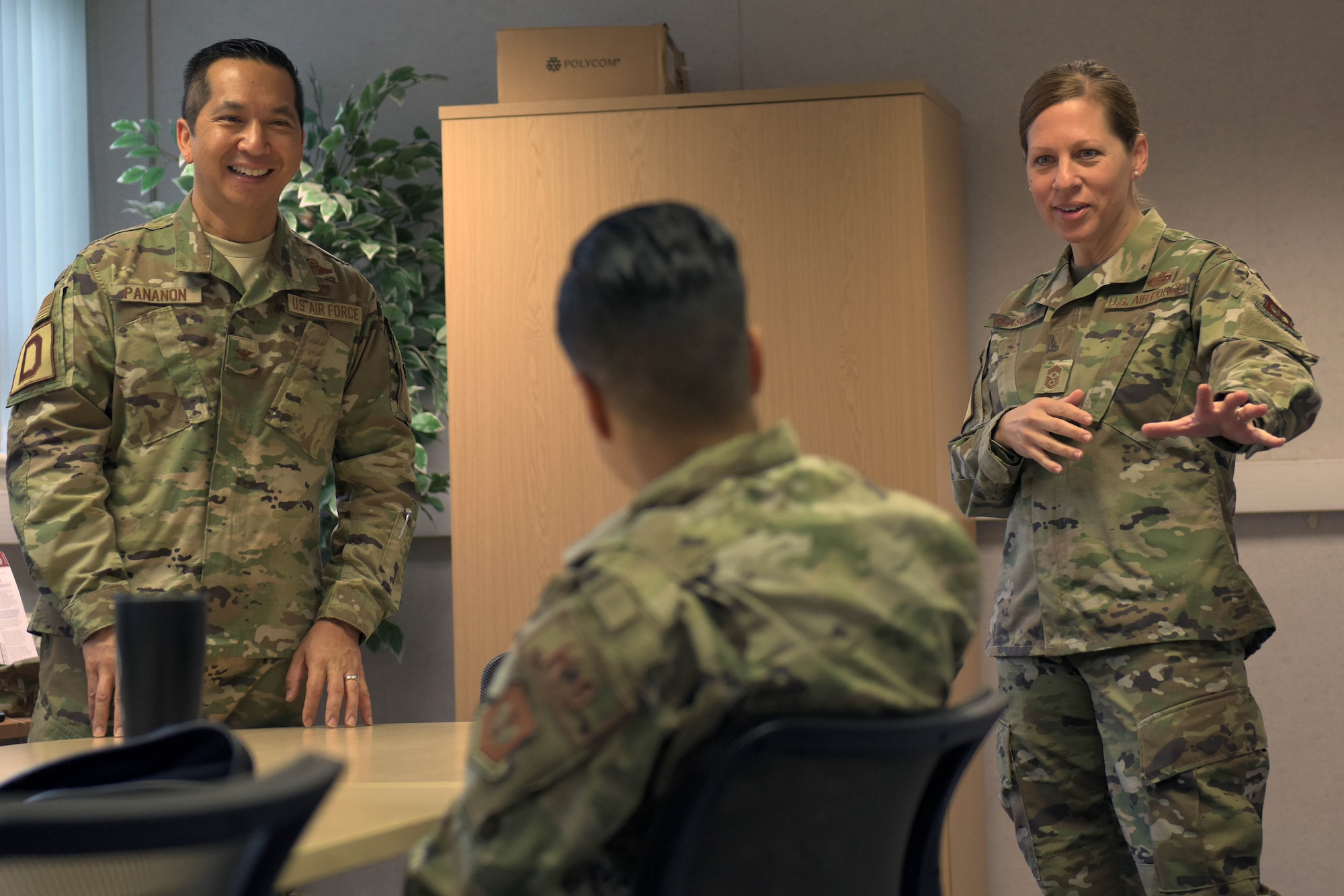 U.S. Air Force Col. Troy Pananon, 100th Air Refueling Wing commander, and Chief Master Sgt. Kathi Glascock, 100th ARW command chief, speak with Staff Sgt. Kristina Santos, 100th Security Forces military working dog trainer, during a reintegration briefing at RAF Mildenhall, England, July 9, 2019. Reintegration briefings occur when Airmen return from deployments to help them re-adjust to post deployment life. (U.S. Air Force photo by Senior Airman Benjamin Cooper)