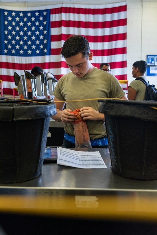 U.S. Air Force Airman 1st Class Bryce Dillman, F-15C Eagle assistant dedicated crew chief assigned to the 44th Aircraft Maintenance Unit, returns a consolidated toolkit during shift turnover June 27, 2019, on Kadena Air Base, Japan.