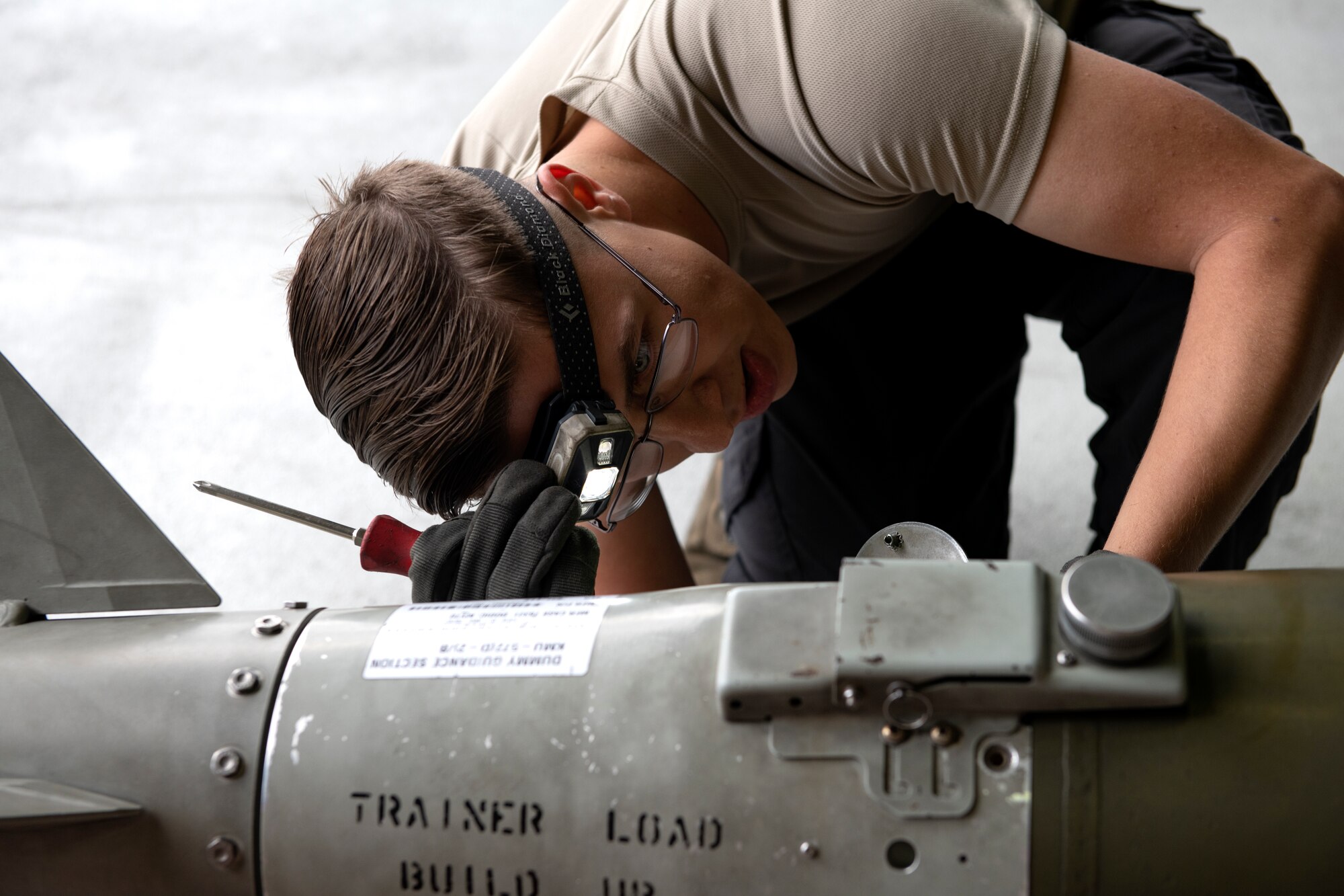 A 494th Aircraft Maintenance Unit weapons load crew member examines ordnance during the 48th Fighter Wing 2019 second quarter Load Crew competition at Royal Air Force Lakenheath, England, July 3, 2019. Load crew competitions help Airmen test their speed and accuracy while focusing on safety and efficiency in a controlled environment. (U.S. Air Force photo by Senior Airman Malcolm Mayfield)