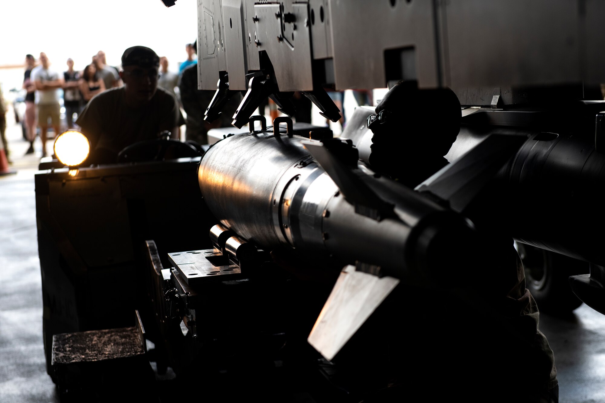 Members of the 494th Aircraft Maintenance Unit weapons load crew equip ordnance onto an F-15E Strike Eagle during the 48th Fighter Wing 2019 second quarter Load Crew competition at Royal Air Force Lakenheath, England, July 3, 2019. Load crew competitions help Airmen test their speed and accuracy while focusing on safety and efficiency in a controlled environment. (U.S. Air Force photo by Senior Airman Malcolm Mayfield)