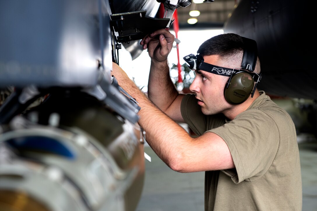 A 492nd Aircraft Maintenance Unit weapons load crew member inspects an armed F-15E Strike Eagle during the 48th Fighter Wing 2019 second quarter Load Crew competition at Royal Air Force Lakenheath, England, July 3, 2019. The 48th Maintenance Group holds quarterly load crew competitions to give Airmen a chance to show off their technical prowess to peers and wing leadership. (U.S. Air Force photo by Senior Airman Malcolm Mayfield)