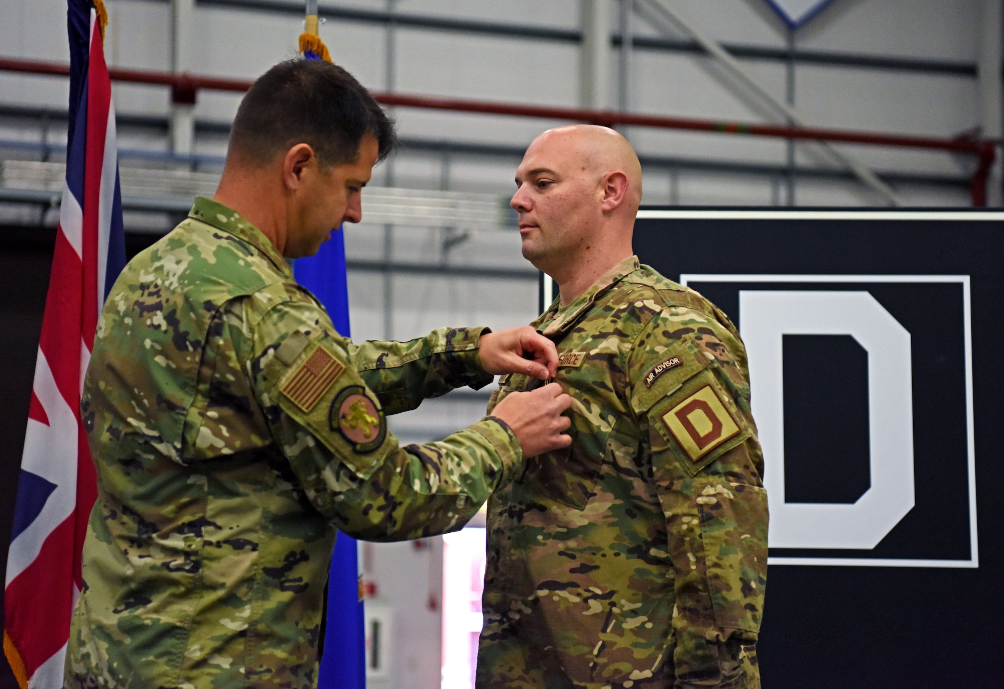 U.S. Air Force Lt. Col. Paul Weme, 100th Maintenance Group commander, pins a Bronze Star Medal on Maj. Aaron Darty, 100th Maintenance Squadron operations officer, during a ceremony held at RAF Mildenhall, England, July 1, 2019. Darty was recently awarded the Bronze Star Medal for meritorious achievement as operations officer and maintenance advisor in support of Operation Freedom Sentinel while deployed to Kandahar Airfield, Afghanistan. (U.S. Air Force photo by Airman 1st Class Brandon Esau)
