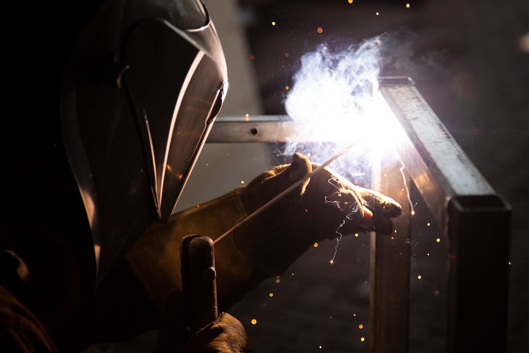 U.S. Marine Corps Cpl. Brandon Martin, a metal fabricator with the Logistics Combat Element, Marine Rotational Force – Darwin, uses a welding tool to assemble a steel frame at Robertson Barracks, Darwin, Australia, July 10, 2019. The LCE provides a unique skillset that allows the MRF-D Marine Air-Ground Task Force to be self-sustaining.