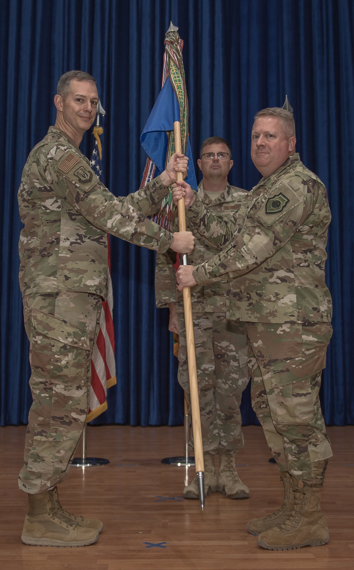 U.S. Air Force Col. Rodney Simpson assumes command of the 386th Air Expedtionary Wing from officiator, Maj. Gen. Alexus G. Grynkewich, 9th Air Expedtionary Task Force-Levant commander, during a change of command ceremony at Ali Al Salem Air Base, Kuwait, July 11, 2019. Simpson took over command of the 386th AEW from Col. Patrick Schlichenmeyer. (U.S. Air Force photo by Tech. Sgt. Daniel Martinez)