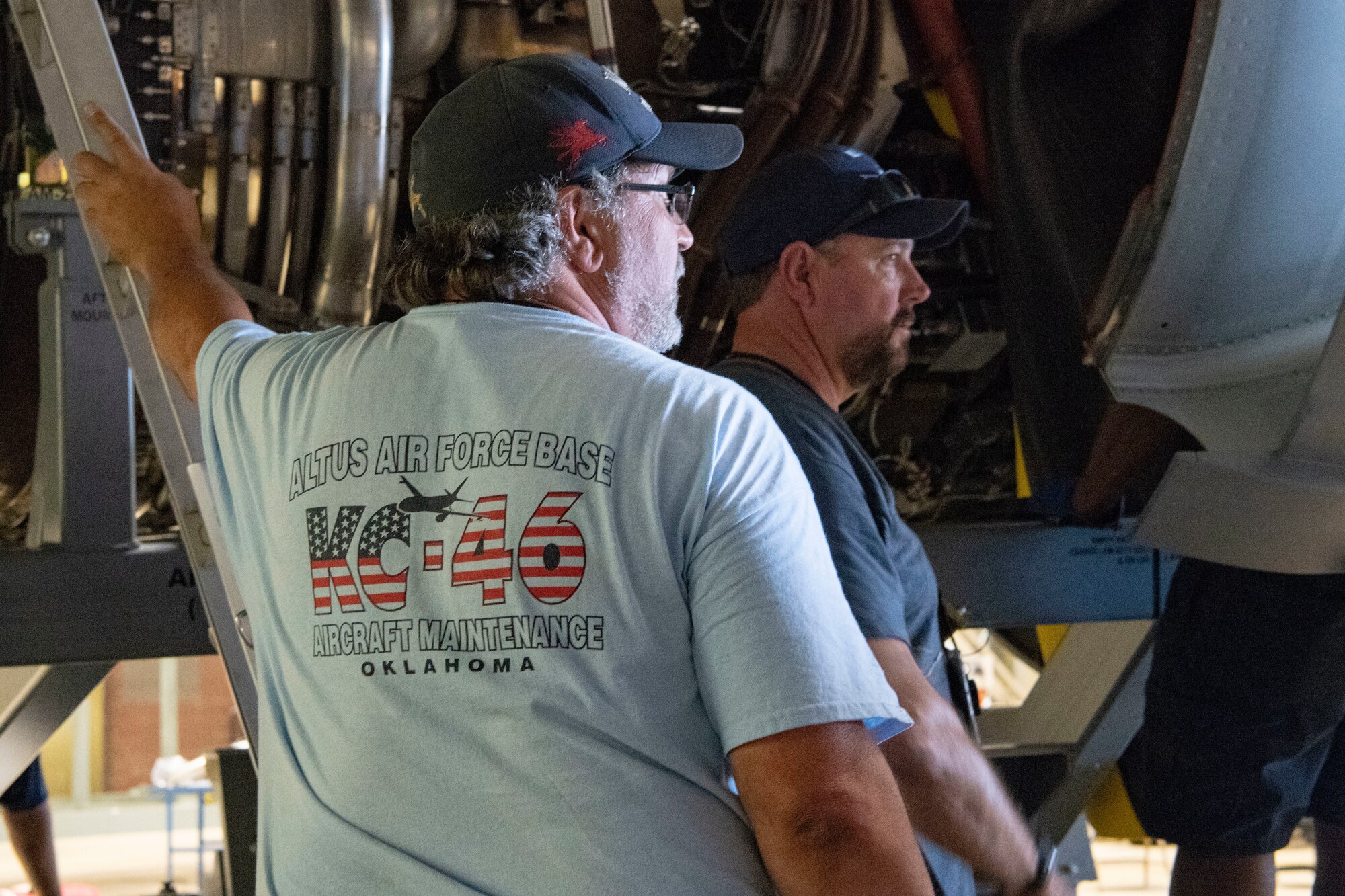 Maintainer watches a KC-46A engine be removed.