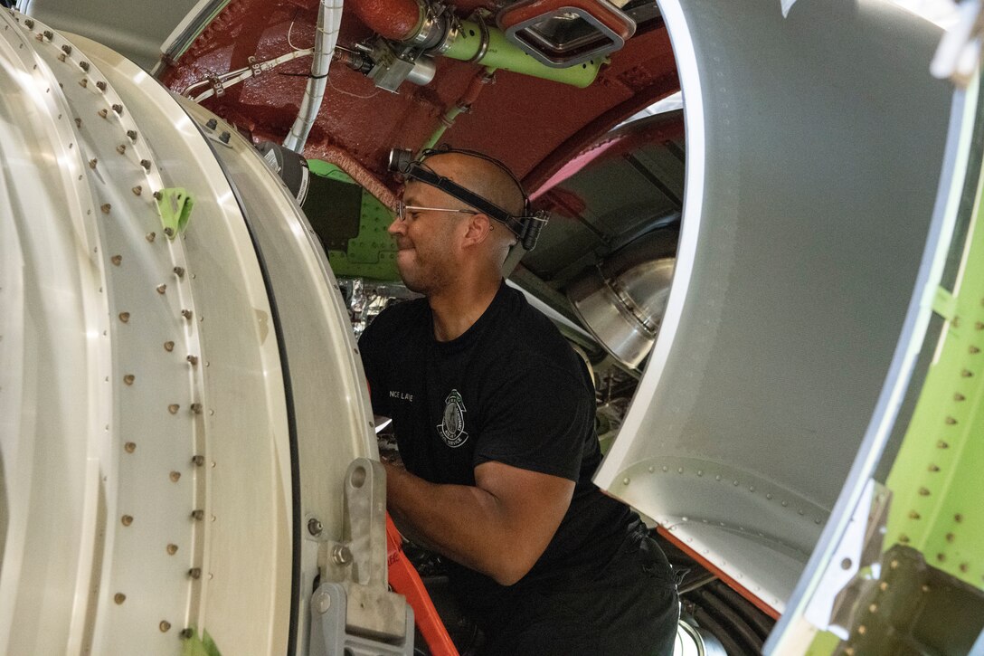 Maintainer helps remove a KC-46A engine.