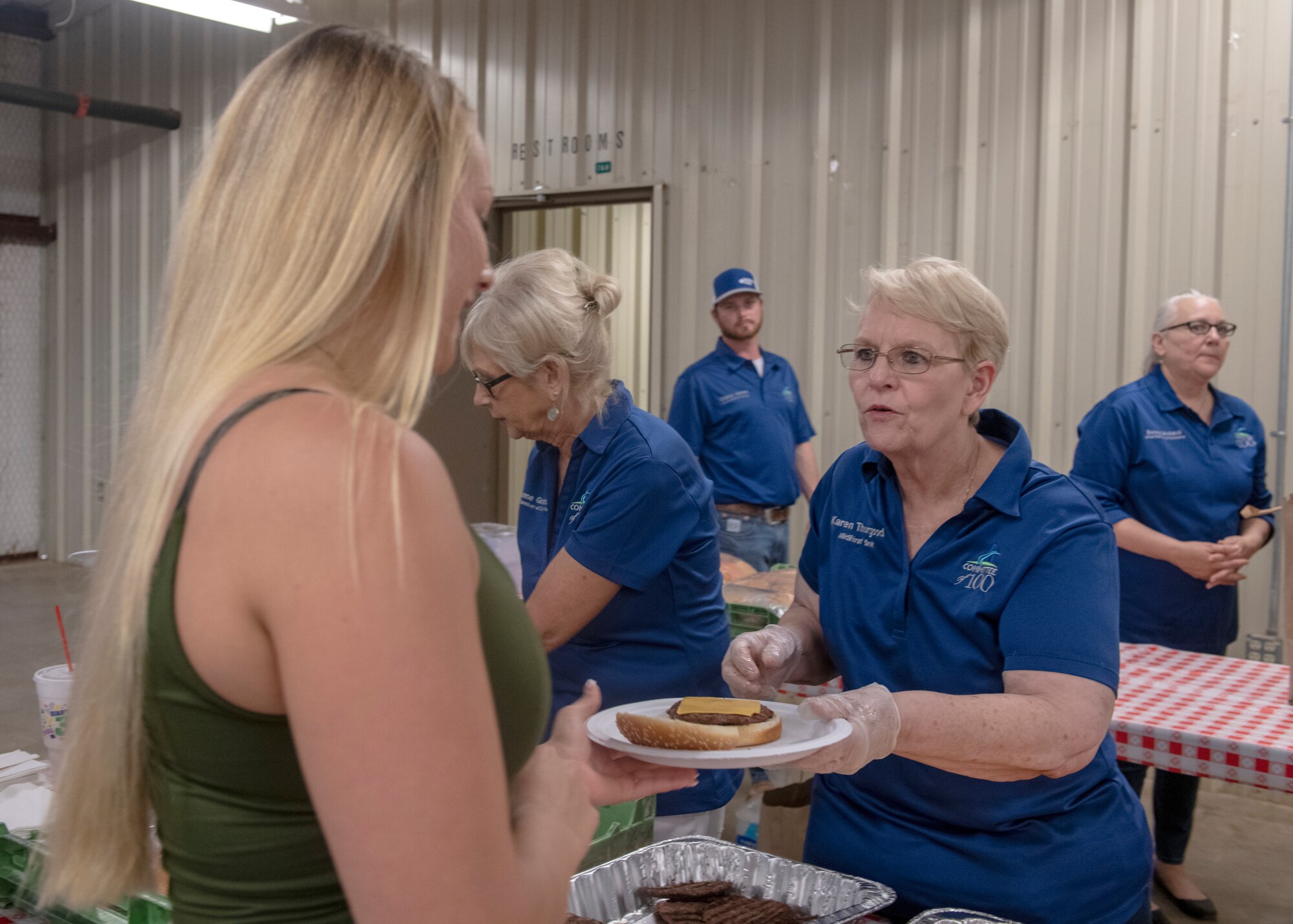 A student from the 97th Training Squadron receives food during the quarterly Committee of 100 dinner, July 8, 2019, at Altus, Okla. The Committee of 100 hosts the dinner celebration offering free food and a welcoming ceremony with games afterwards.