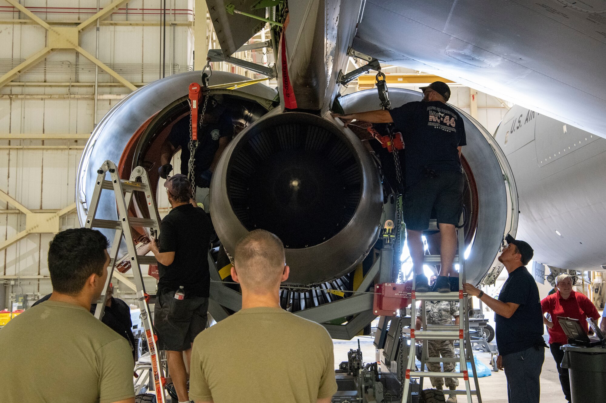 Maintainers remove a KC-46A engine.