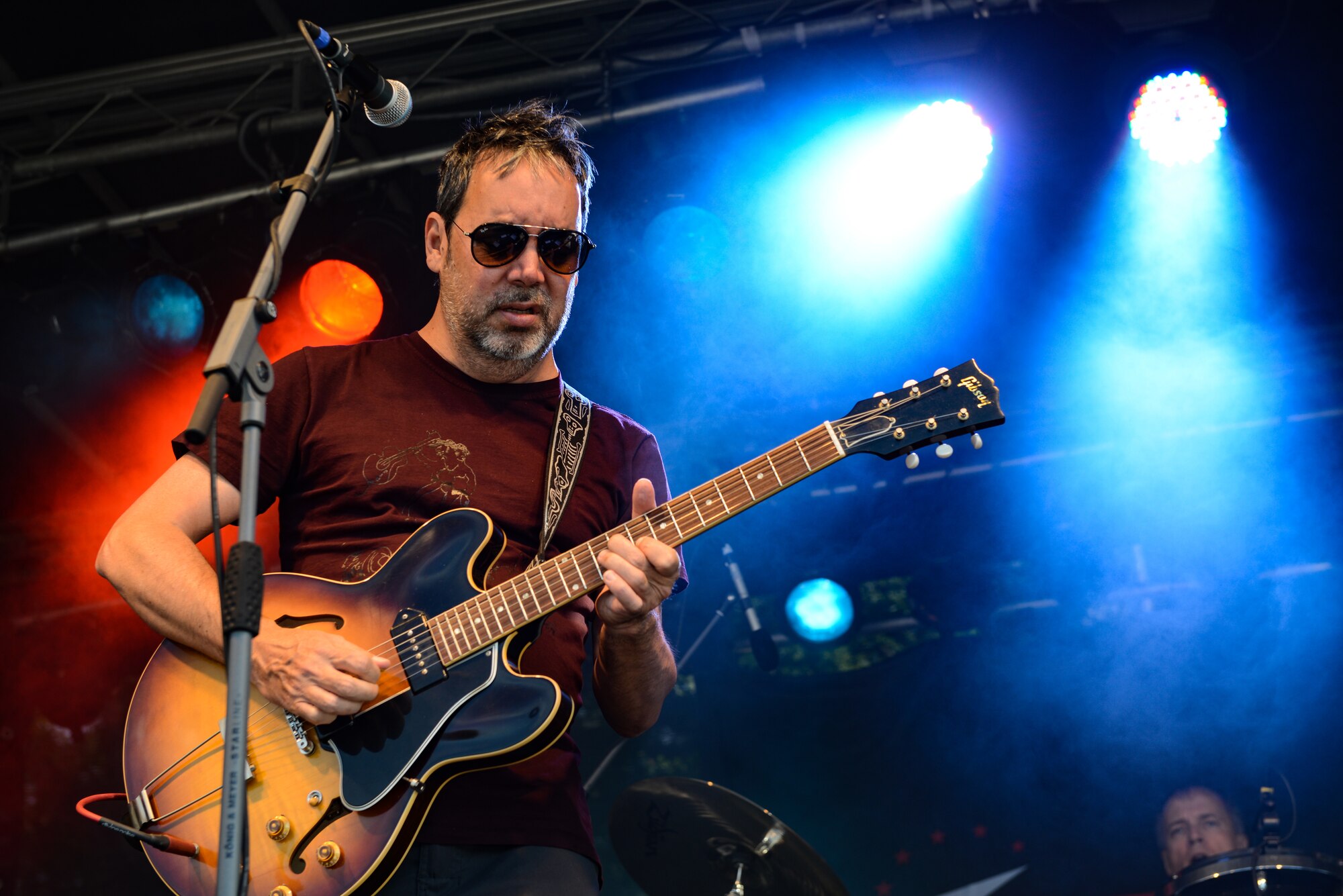 Miles Zuniga, a guitarist and vocalist for the American rock band, Fastball, plays an electric guitar on stage during a live concert for Freedom Fest on Ramstein Air Base, Germany, July 3, 2019.