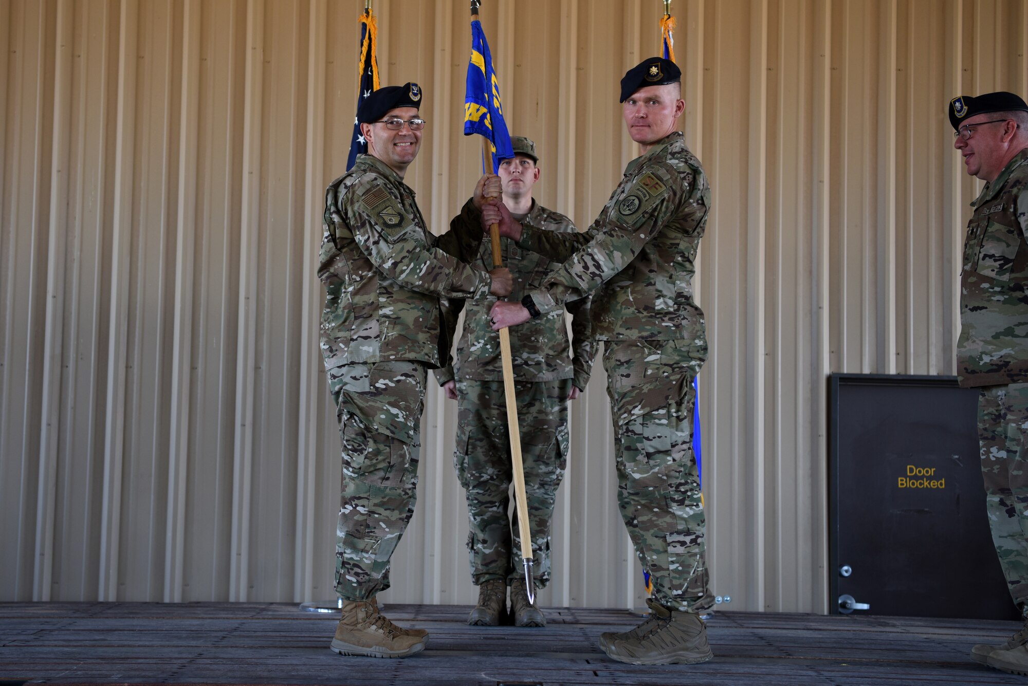 U.S. Air Force Maj. Shawn Chamberlin, left, accepts the guidon and command of the 377th Weapon System Security Squadron from Col. Theodore Breuker, 377th Security Forces Group commander, during a change of command ceremony at Kirtland Air Force Base, N.M., July 9, 2019. Chamberlin previously commanded the 377th Security Forces Squadron. (U.S. Air Force photo by Senior Airman Eli Chevalier)