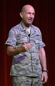 Gen. Mike Holmes, commander of Air Combat Command, hosts a town hall meeting to discuss the future 24th and 25th Air Force merger at Joint Base San Antonio-Lackland July 8. Holmes discussed the purpose and plan of the information warfare numbered Air Force and fielded several questions from attendees.