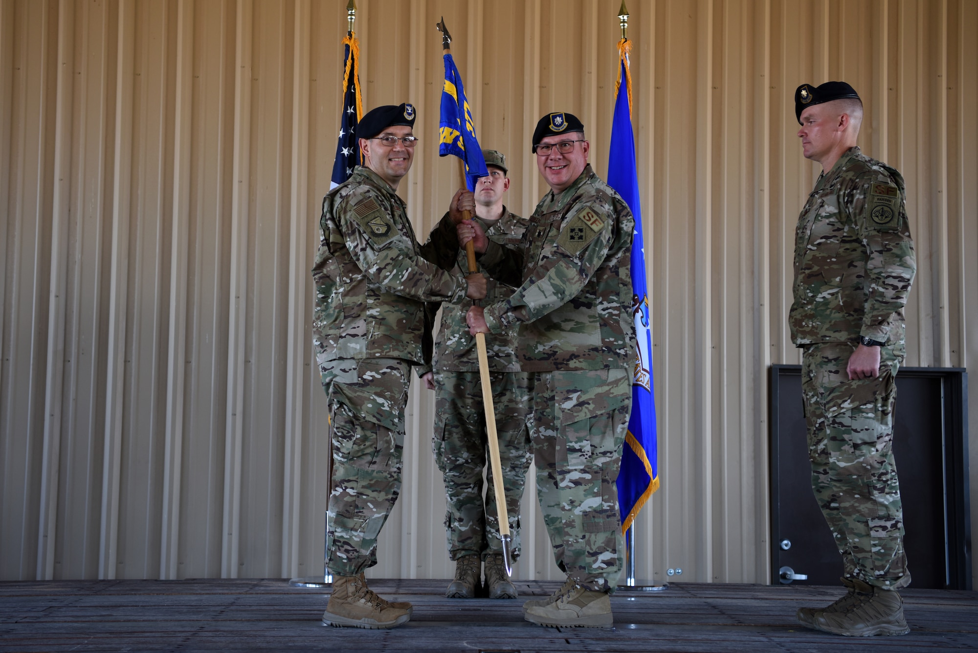 U.S. Air Force Lt. Col. Joseph Parsons, right, outgoing 377th Weapon System Security Squadron commander, passes the guidon to Col. Theodore Breuker, 377th Security Forces Group commander, during a change of command ceremony at Kirtland Air Force Base, N.M., July 9, 2019. Parsons is scheduled to retire from active duty on July 10, 2019. (U.S. Air Force photo by Senior Airman Eli Chevalier)