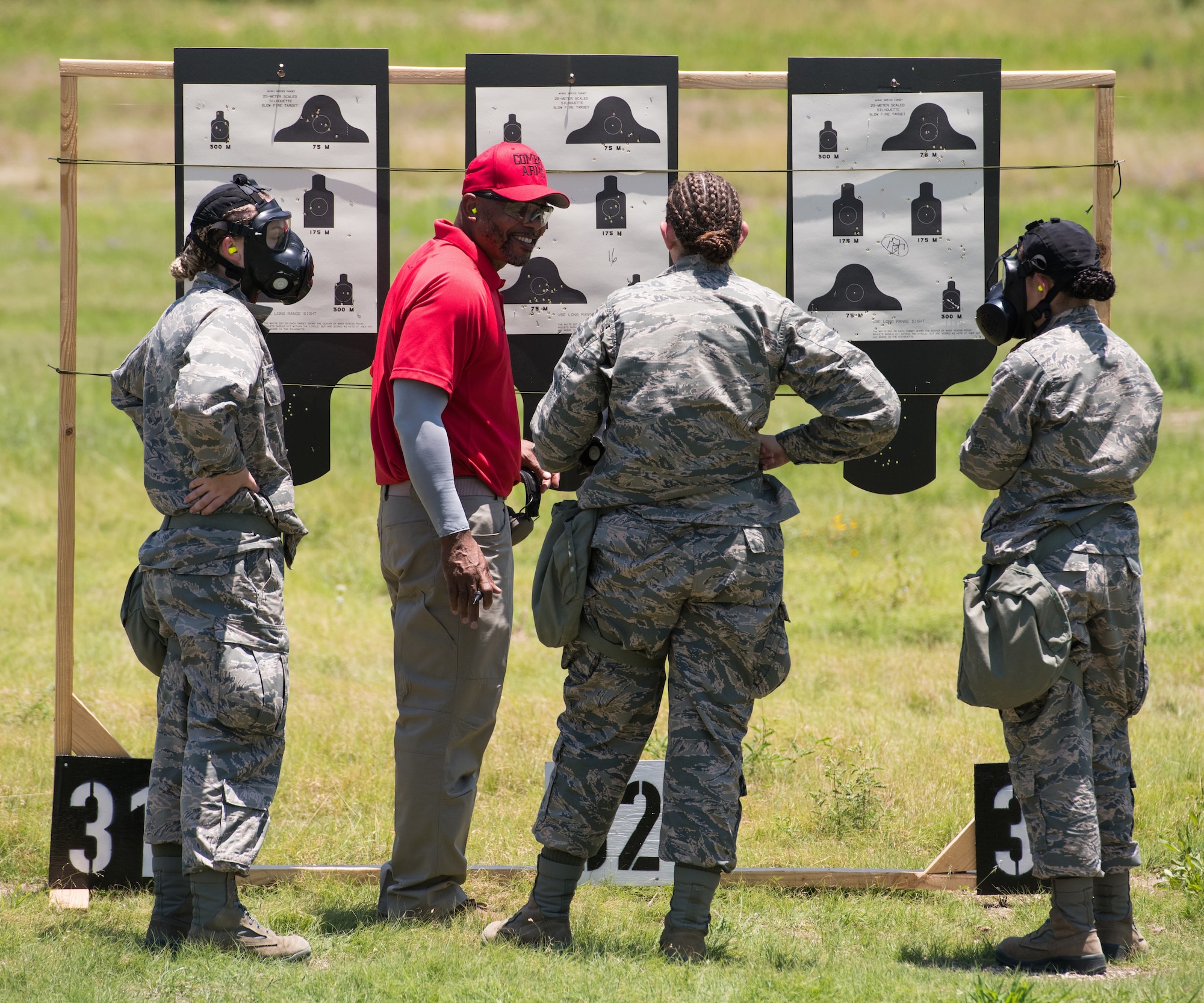 Nate Cade, 37th Training Support Squadron combat arms instructor, evaluates targets with Basic Military Training trainees during a weapons familiarization course July 8 at Joint Base San Antonio-Medina Annex. The firing range allows instructors to train 244 BMT trainees daily, four days a week, qualifying more than 40,000 BMT trainees in the M-4 carbine annually.