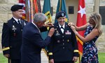 Donald Roman Sr. (left) and Rebecca Roman add shoulder boards reflecting the new rank of Brig. Gen. Christine Beeler as Maj. Gen. Paul Pardew looks on during a promotion ceremony July 9 at Joint Base San Antonio-Fort Sam Houston, Texas. Donald is the father of the commanding general for the Mission and Installation Contracting Command, and Rebecca is her sister. Pardew, who officiated the ceremony, is the commanding general for the Army Contracting Command at Redstone Arsenal, Alabama.