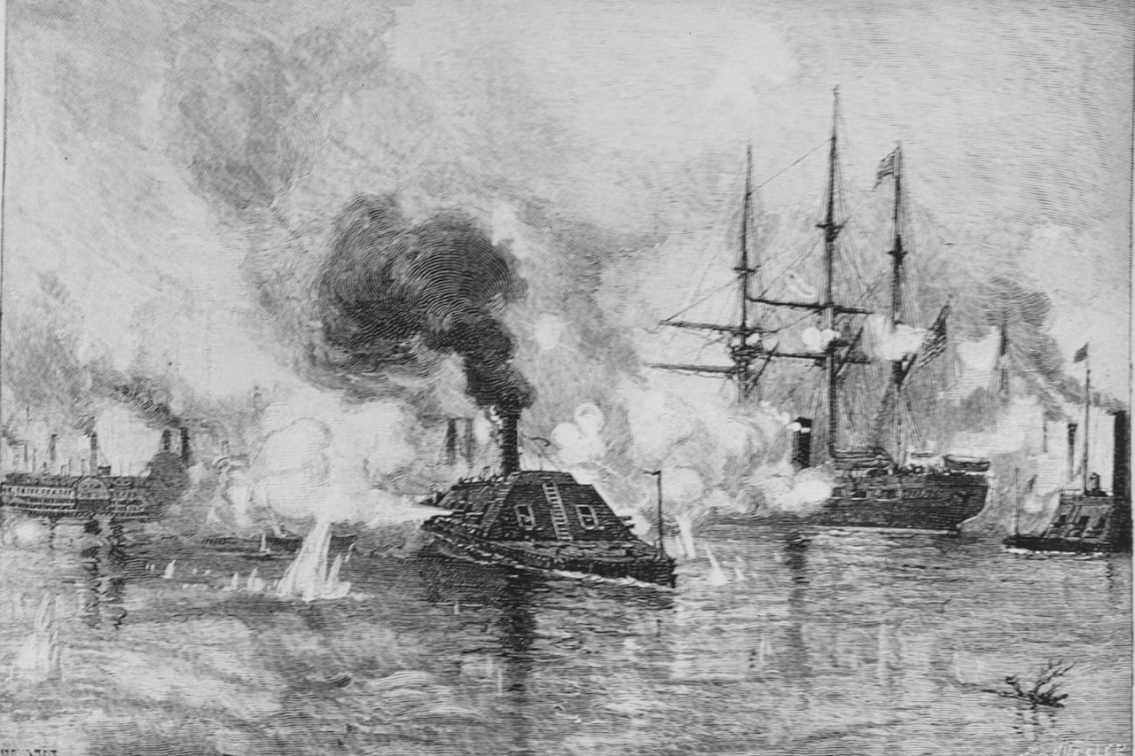 An ironclad gunboat billowing smoke or steam rams through a waterway surrounded by an enemy gunboat, a tall ship and another ship. Water is splashing up where ammo has hit he river.