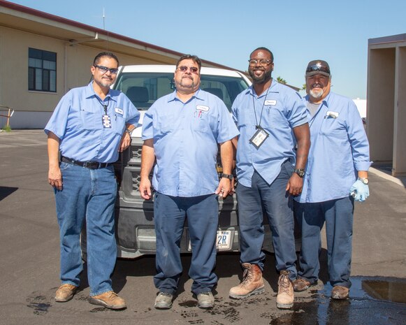 Richard Gallegos (Left) , utilities supervisor poses for a photo with utilities systems repairers  and operators, Thomas Maes, Donato Powell, and Paul Borruel, aboard Marine Corps Logistics Base Barstow, Calif., July 10.